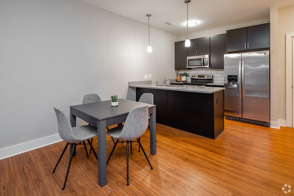 a kitchen and dining room with stainless steel appliances and a table