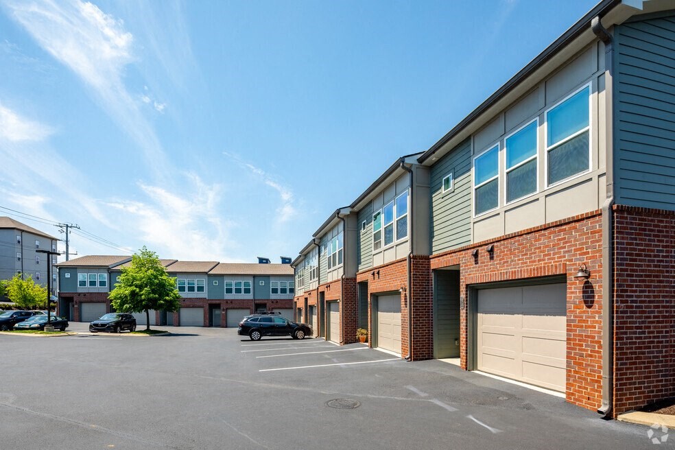a parking lot with brick buildings and garages