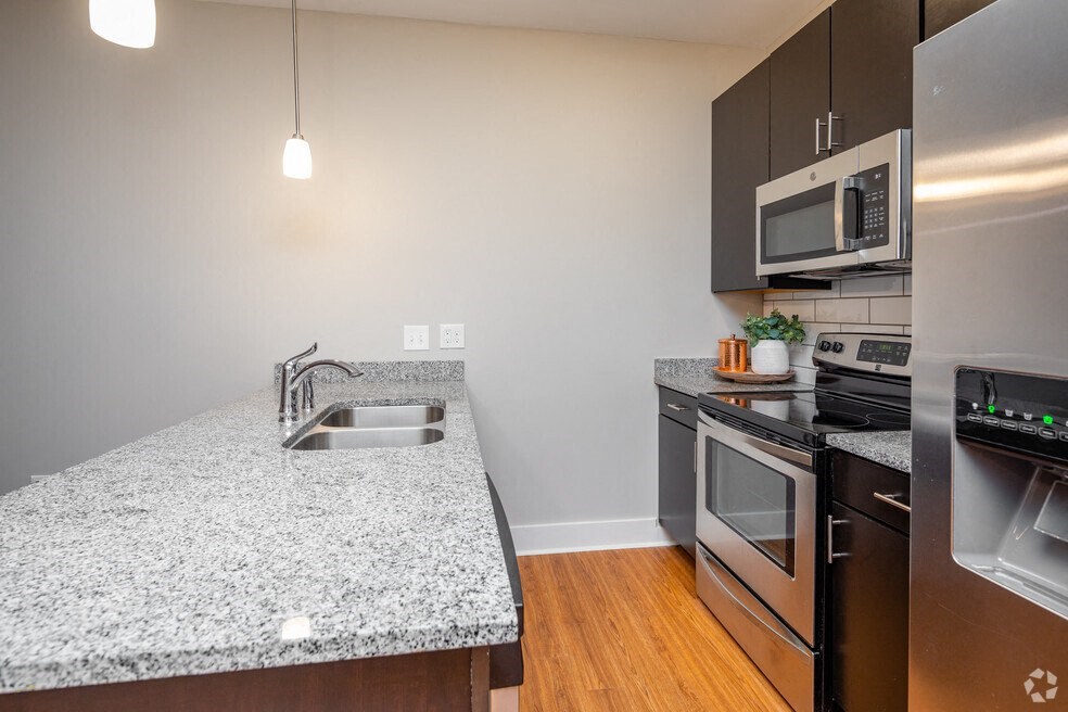 a kitchen with granite counter top and stainless steel appliances