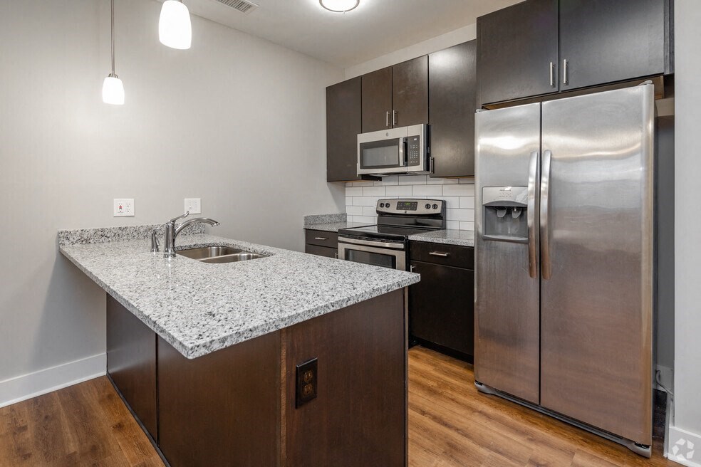a kitchen with stainless steel appliances and a granite counter top
