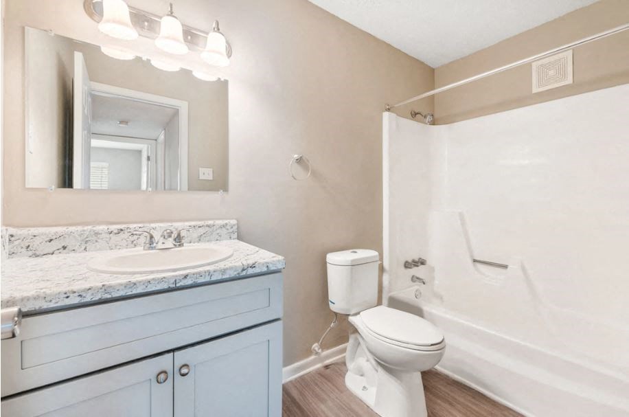 a bathroom with a sink toilet and a shower