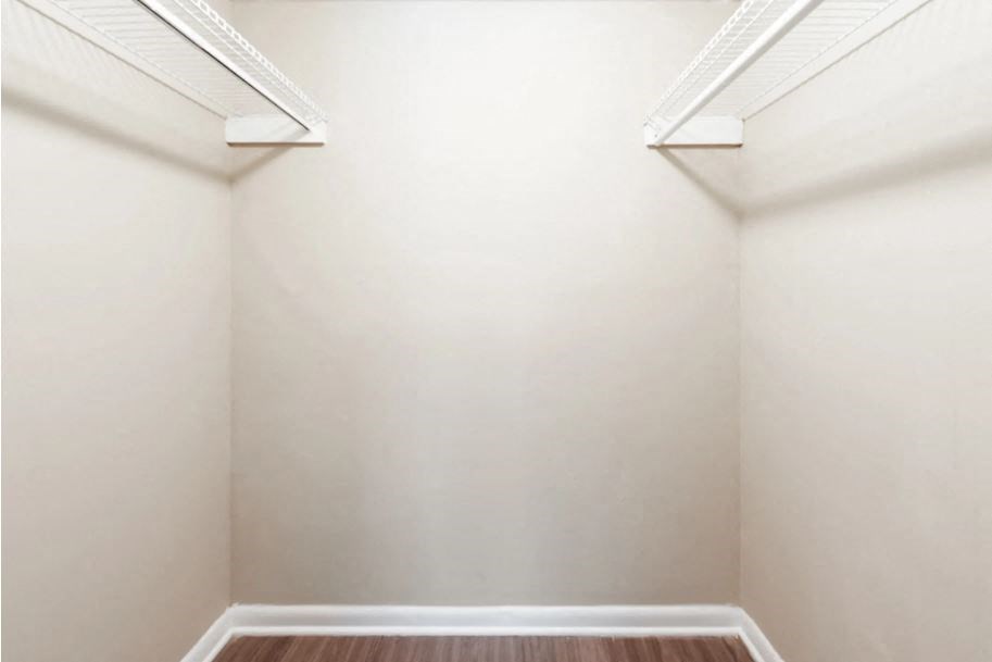 a empty room with white walls and a wooden floor