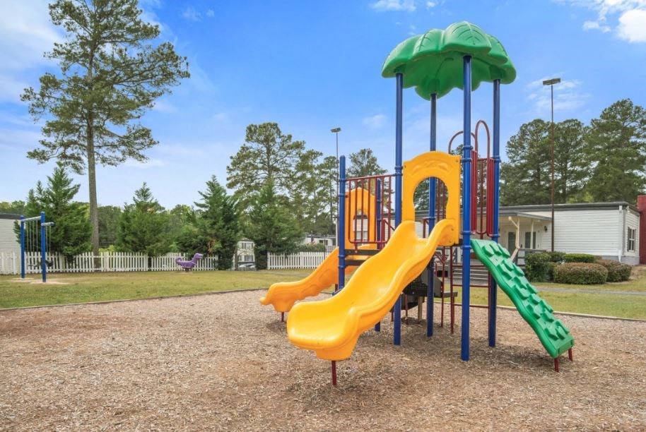 a playground with a swing set and slides