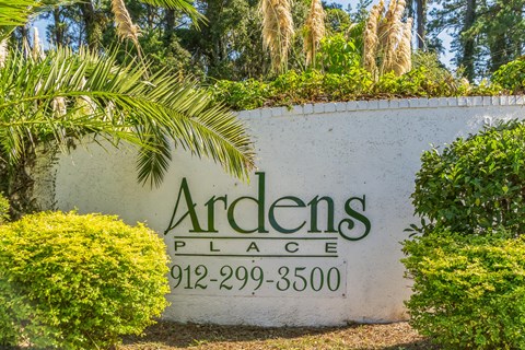 a sign for andenes place in front of trees and bushes