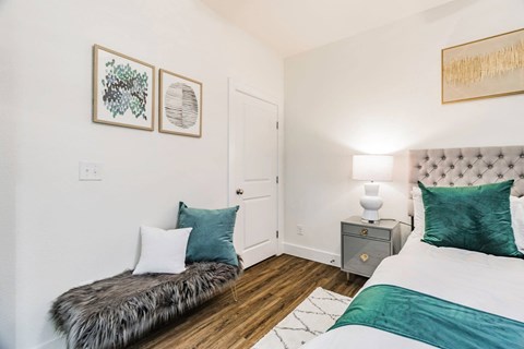 a bedroom with two beds and a nightstand with a lamp
