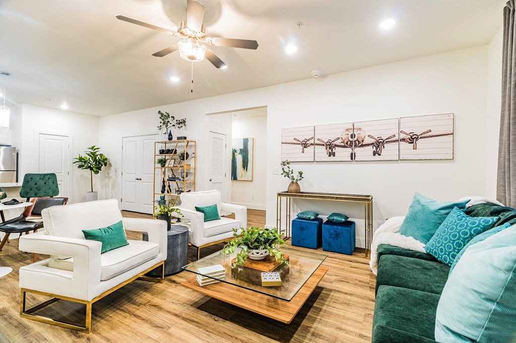 a living room filled with furniture and a ceiling fan