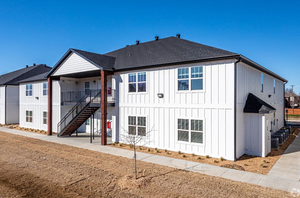 a white building with a gray roof on a sunny day