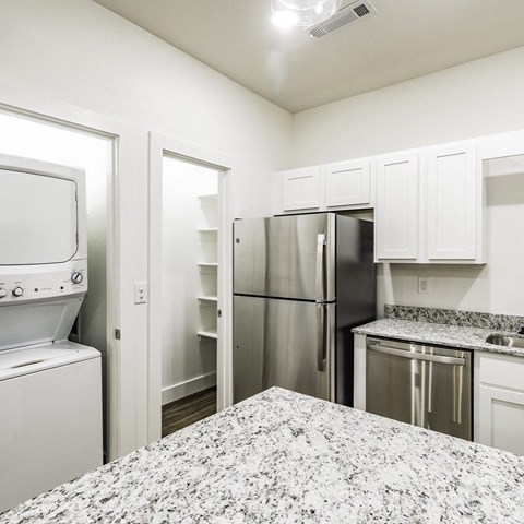 a kitchen with stainless steel appliances and granite counter tops