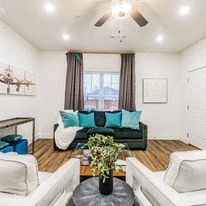 a living room filled with furniture and a large window