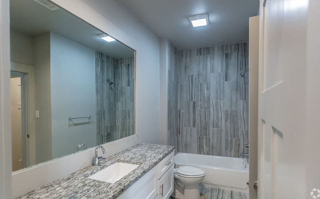 a bathroom with a sink toilet and bathtub