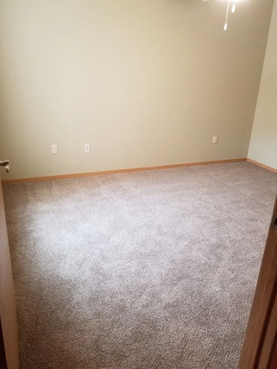 a room with a carpeted floor and white walls