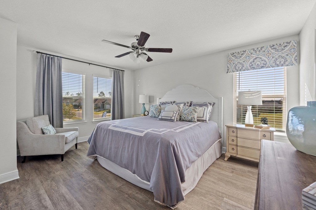 a bedroom with a bed and a ceiling fan