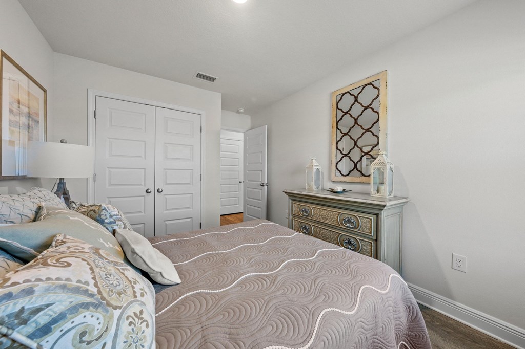 a bedroom with a bed and a dresser