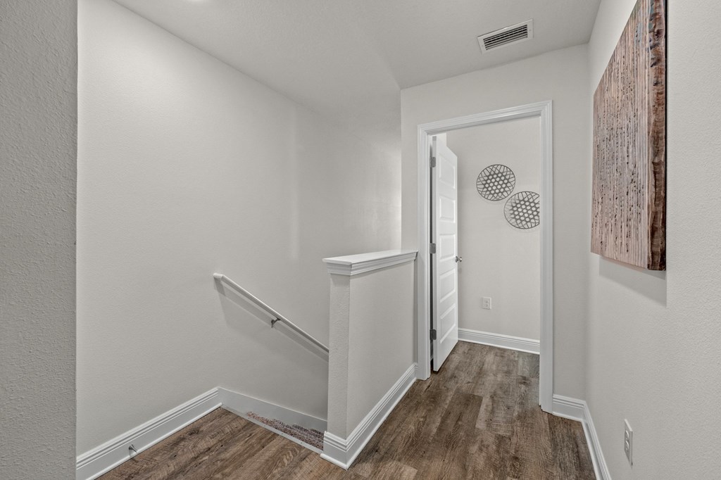 a bedroom with a medium sized bed and a chair in a room