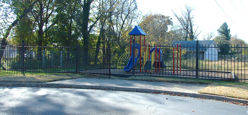 a playground in a park with a swing set