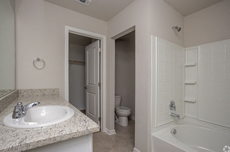 a bathroom with a sink and a shower and a toilet
