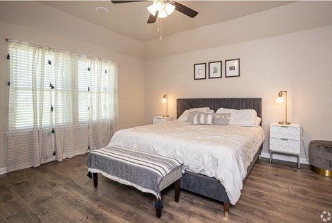 a bedroom with a bed and a ceiling fan