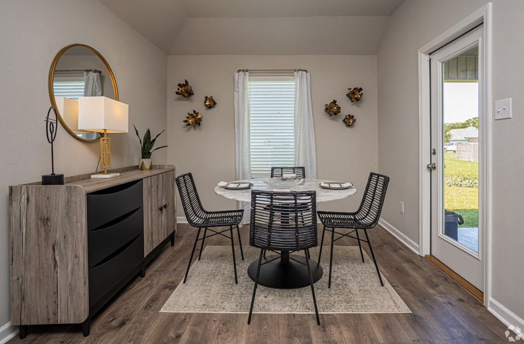 a dining room with a table and chairs