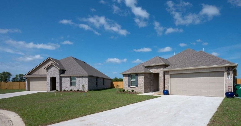 a house in a subdivision with a driveway and a garage