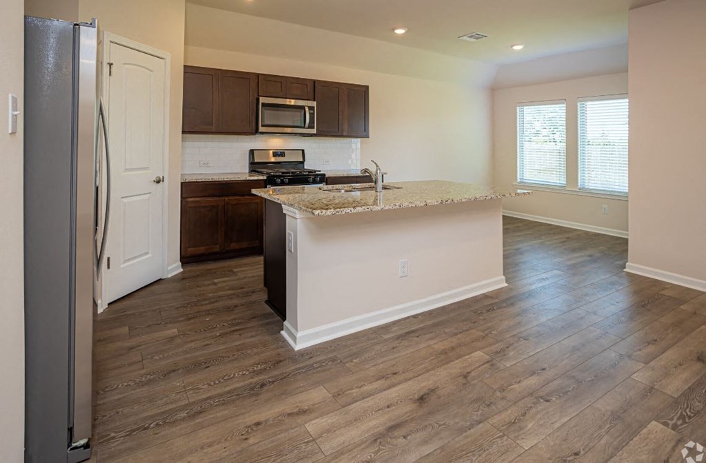 a kitchen with a counter top and a refrigerator