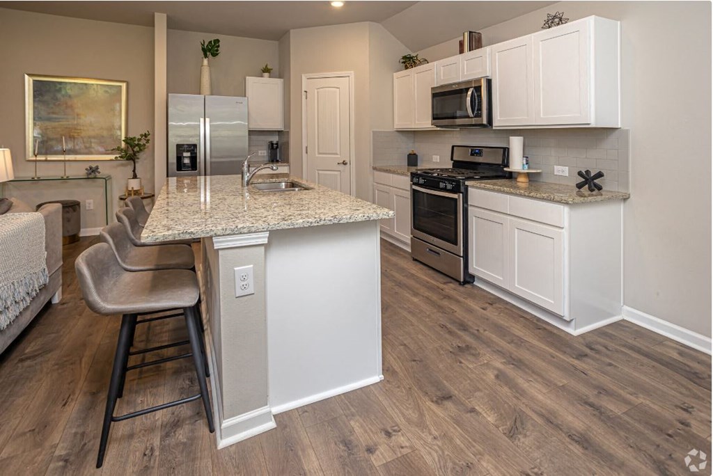 a kitchen with a marble counter top and