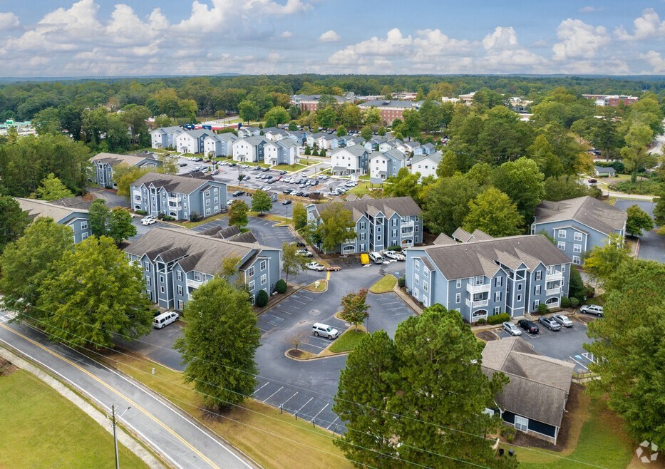 an aerial view of an apartment complex with blue and gray buildings