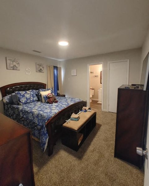 a bedroom with a bed and a table