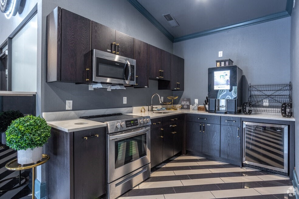 a kitchen with stainless steel appliances and a microwave