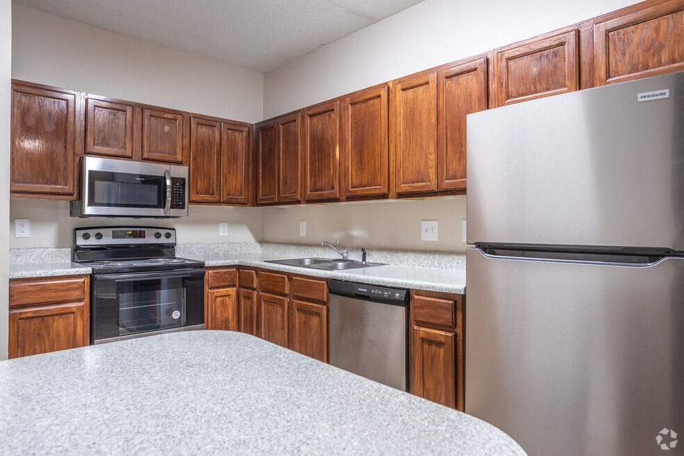 a kitchen with stainless steel appliances and wooden cabinets