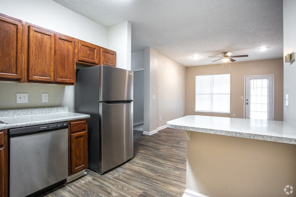 a kitchen with stainless steel appliances and wooden cabinets