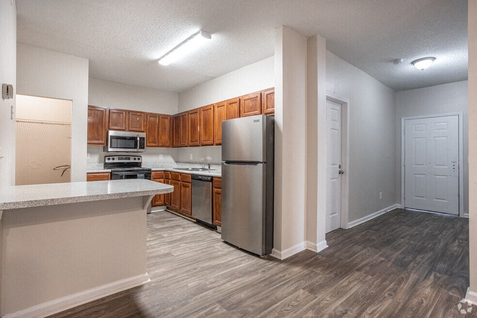a kitchen with stainless steel appliances and wooden cabinets