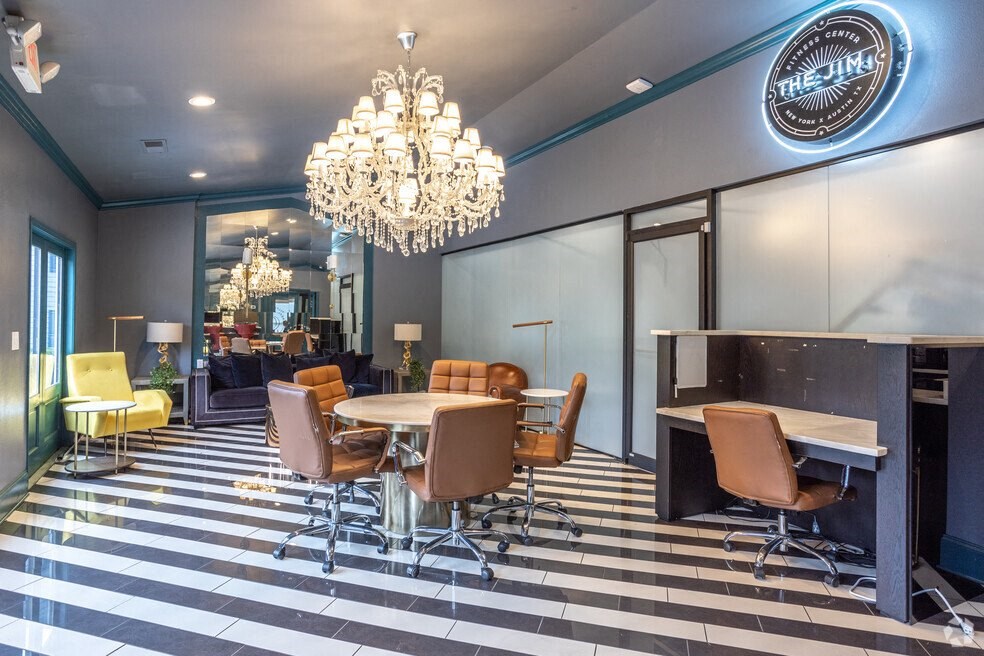 a dining room with a chandelier and a table and chairs