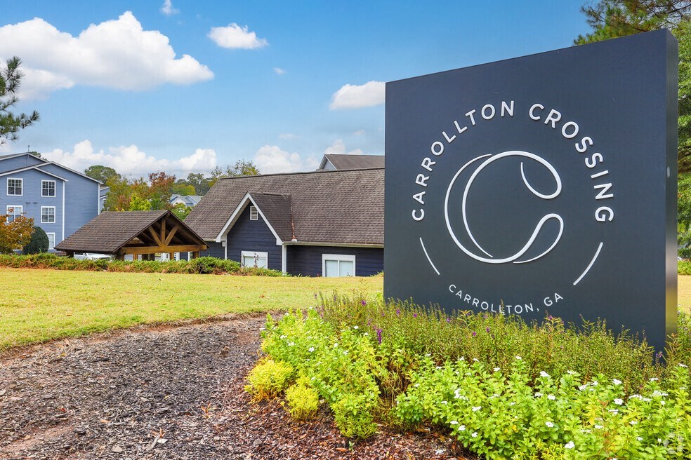 a large sign in front of a crescent crossroads sign