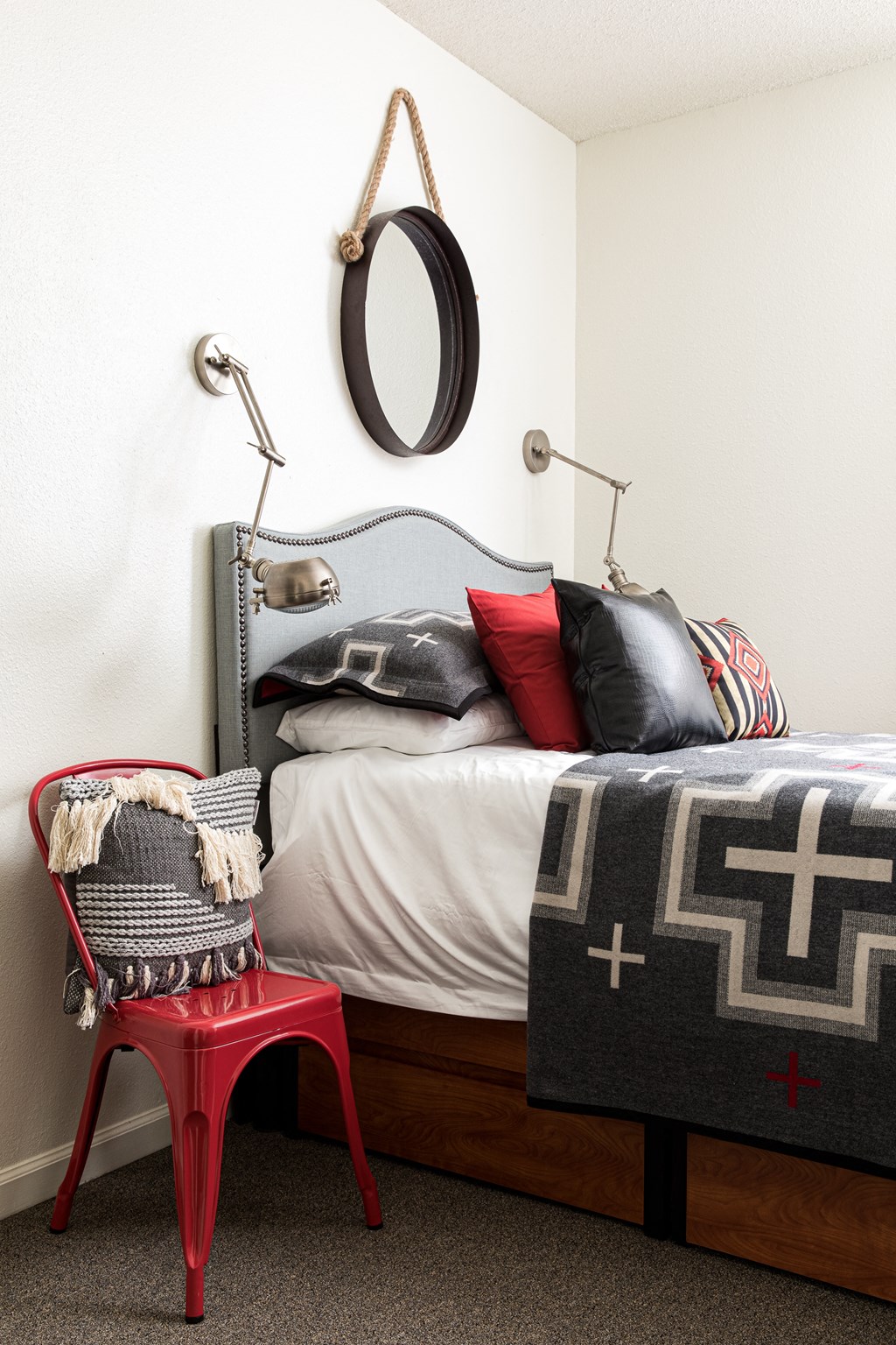 a bedroom with a bed and a red chair