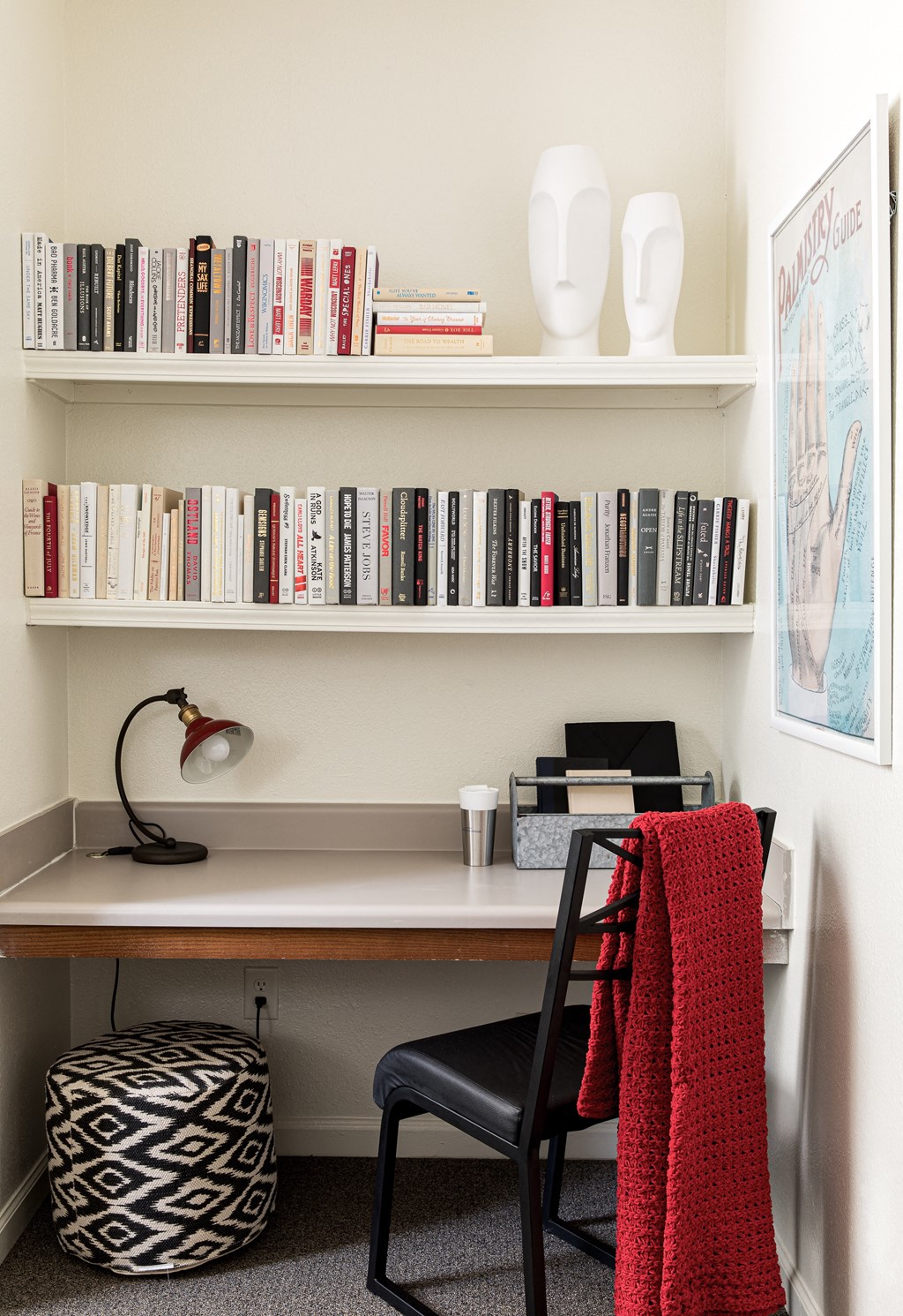 a home office with a desk and bookshelves