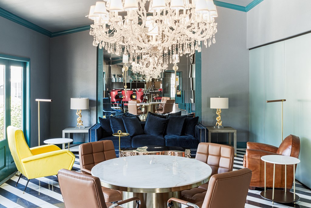 a living room with blue walls and a white chandelier