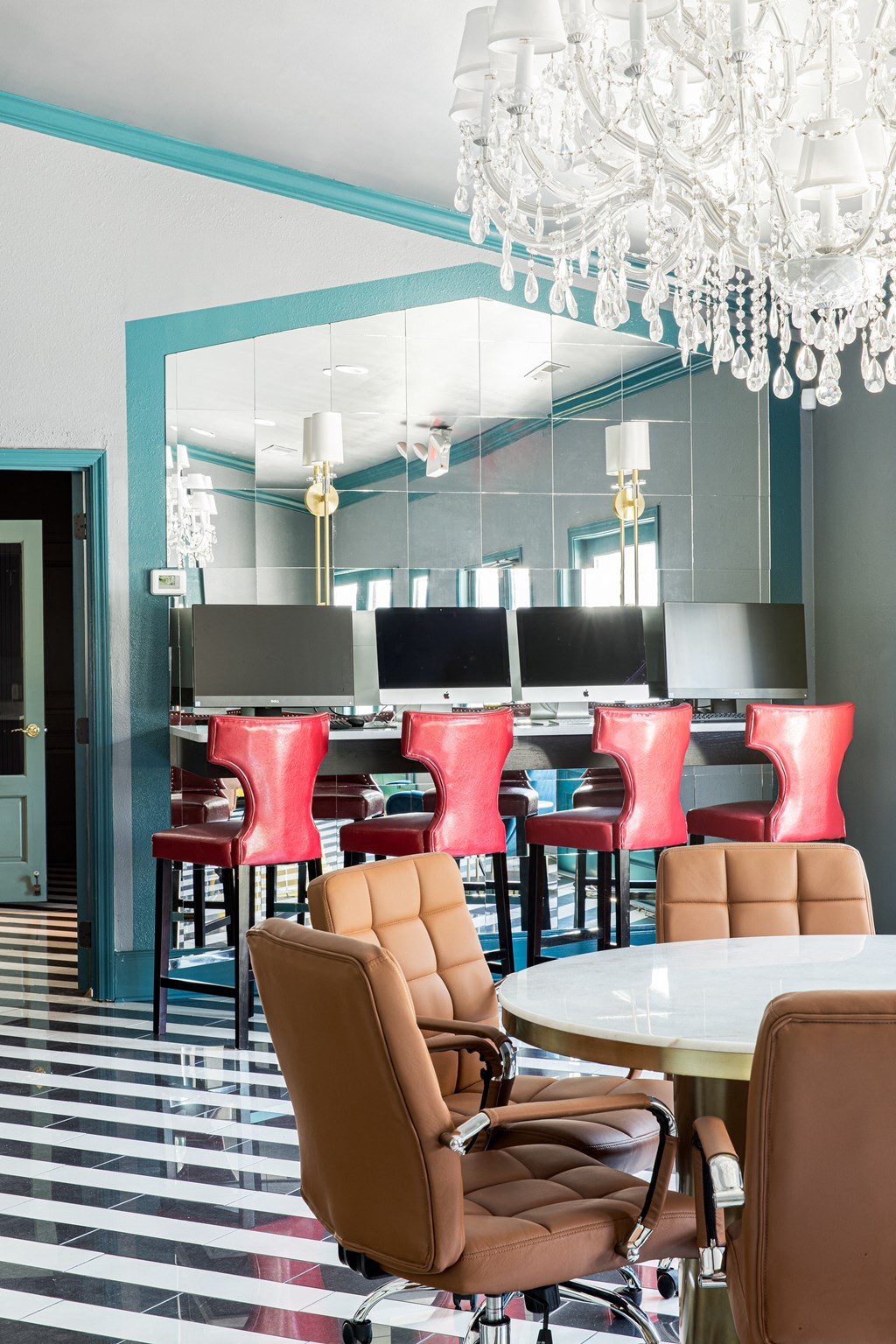 a dining room with a chandelier and chairs