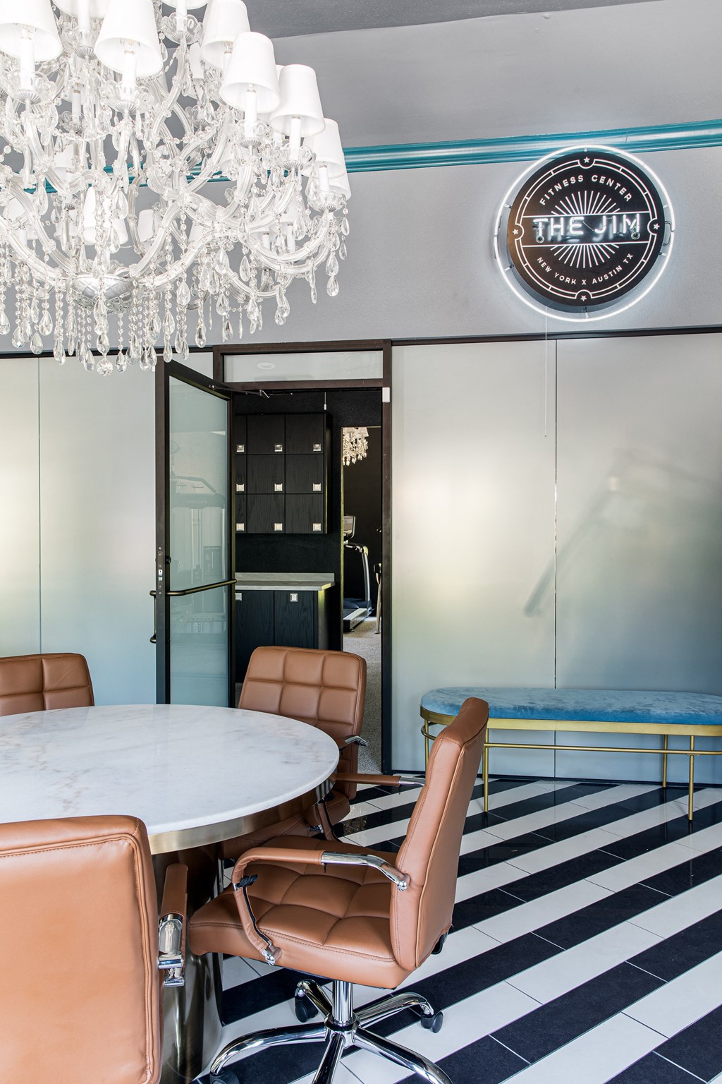 a dining room with a marble table and leather chairs