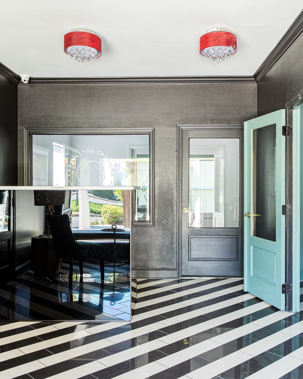 a dining room with a blue door and a black and white checkered floor