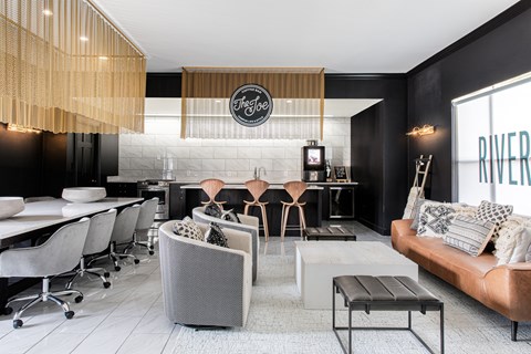 a living room and kitchen with black walls and white floors