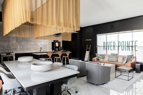 a kitchen and living room with black walls and white tiles