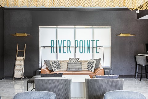 a living room with a couch and chairs in front of a window with the words river point