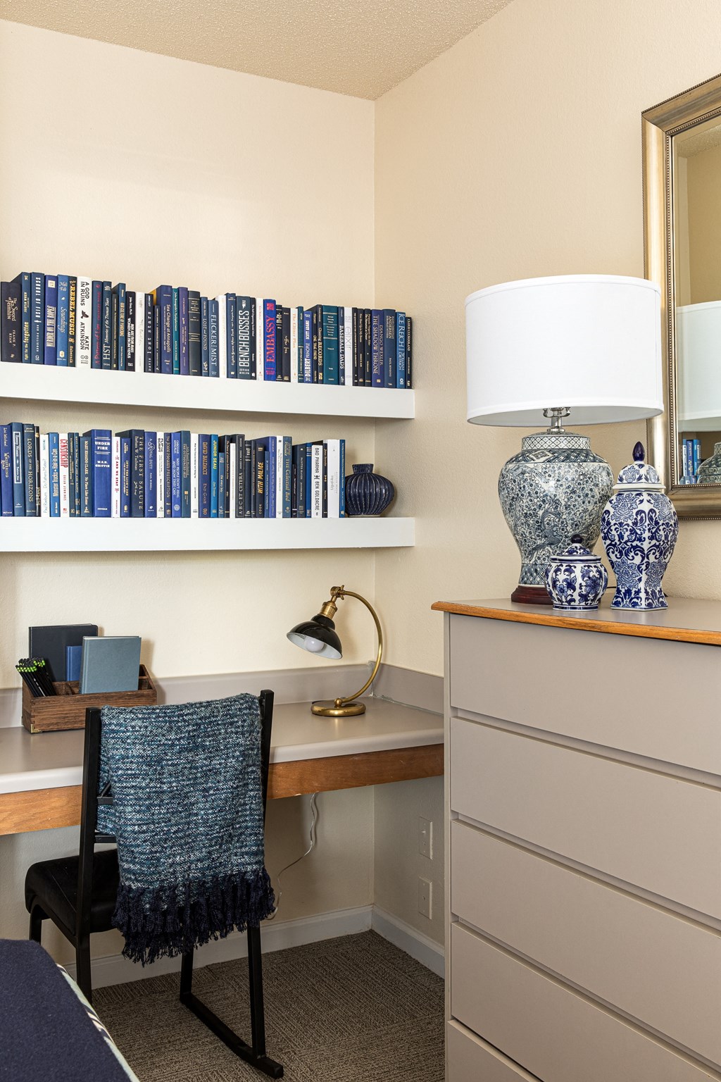 a home office with a desk and bookshelves