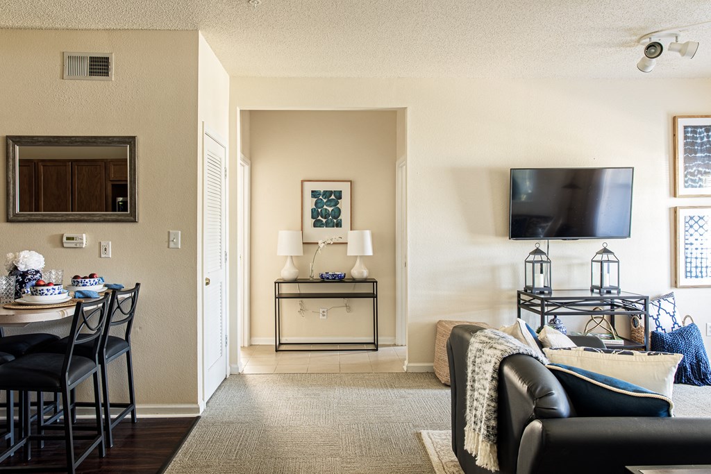 a living room with a tv and a table with chairs