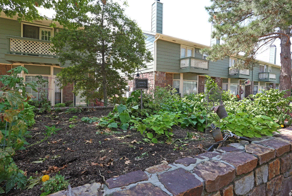 a garden in front of an apartment building