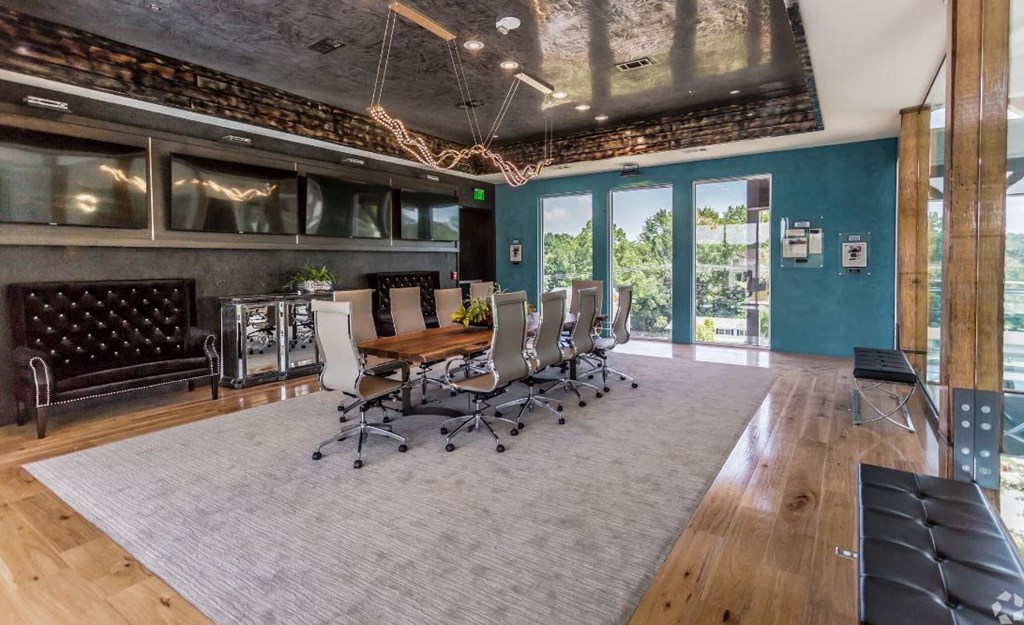 a conference room with a long wooden table and chairs