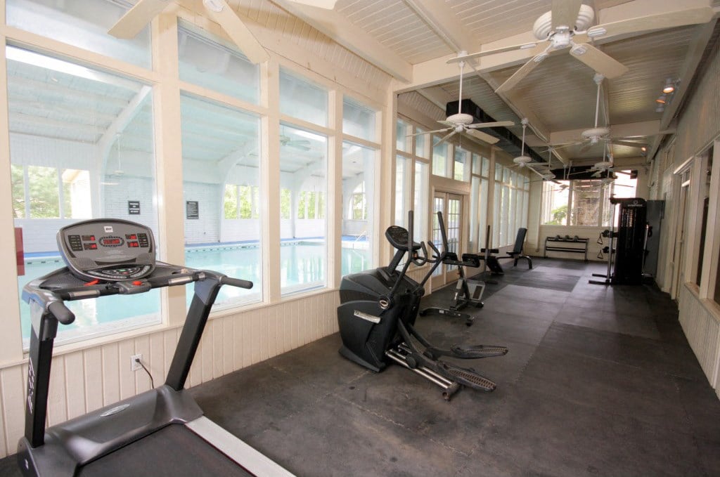 the gym is located on the porch overlooking the pool
