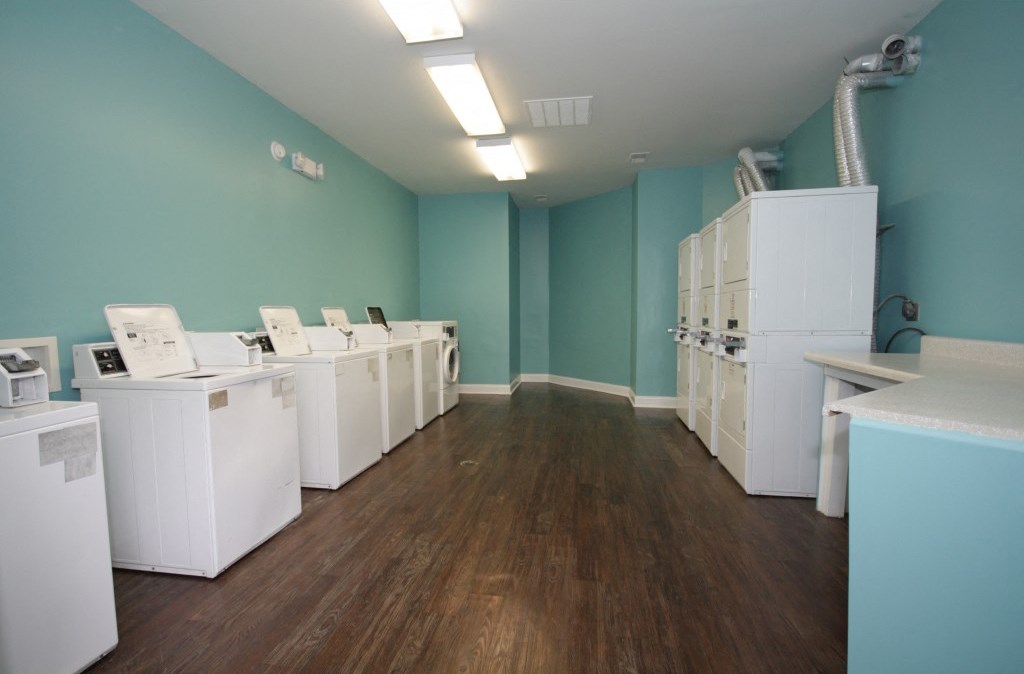 a room filled with washes and dryers in it