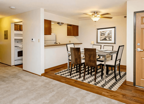 a dining room and kitchen with a table and chairs
