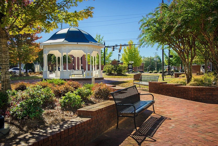 a gazebo and benches in a park